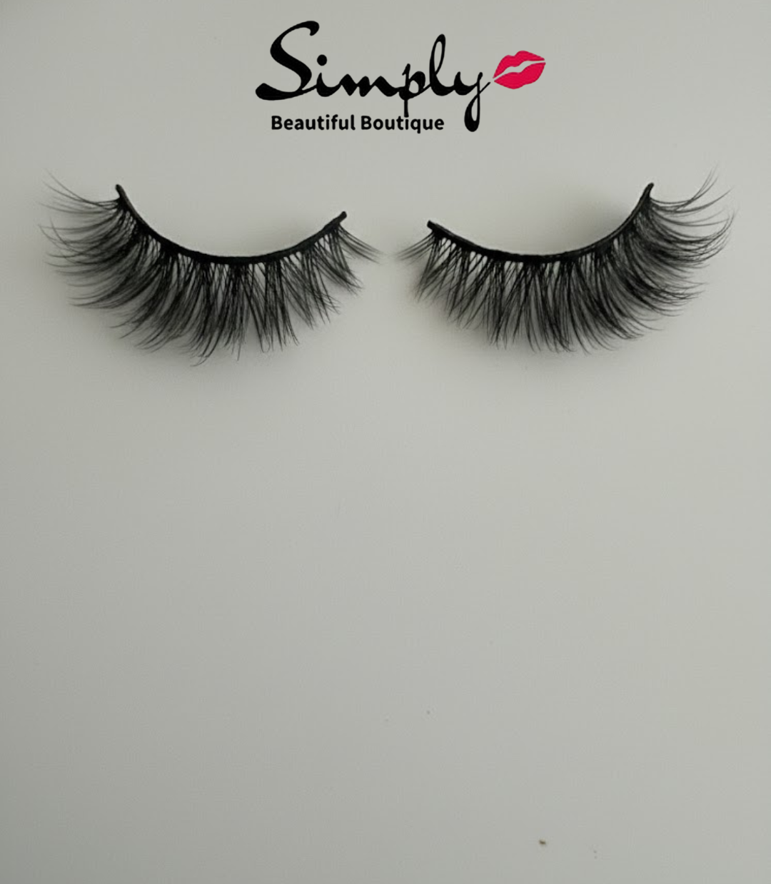 Bossy Strip Lashes. Pair of false eyelashes on a white background with 'Simply Beautiful Boutique' branding.